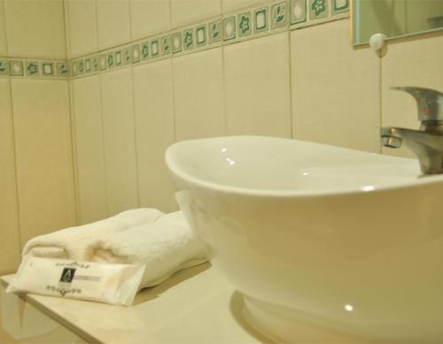 a bathroom with a sink and a towel on a counter at A Hotel Baguio in Baguio