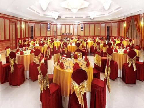 a large banquet hall with yellow and red tables at Le Dian Hotel in Serang