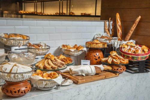 a buffet of pastries and breads on a table at InterContinental Dhaka by IHG in Dhaka