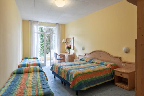 Ein Bett oder Betten in einem Zimmer der Unterkunft Hotel Marco Polo