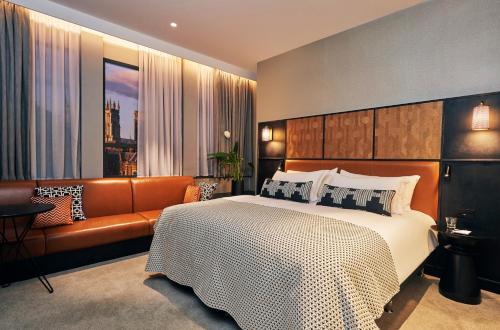 a bedroom with a large bed and a couch at Malmaison York in York