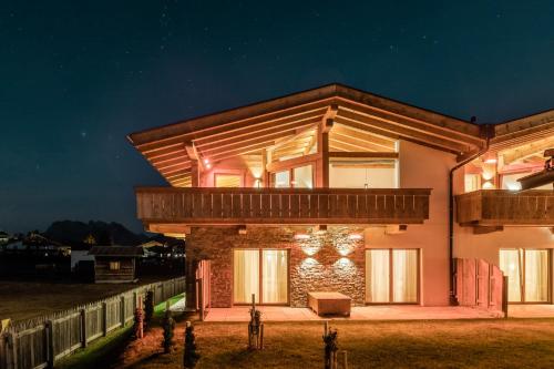 a house with a lit up facade at night at Löwen Chalets in Seefeld in Tirol