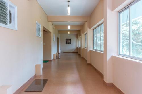an empty hallway in a hospital with a window at KSTDC Hotel Mayura Kauvery KRS in Hosa Kannambādi