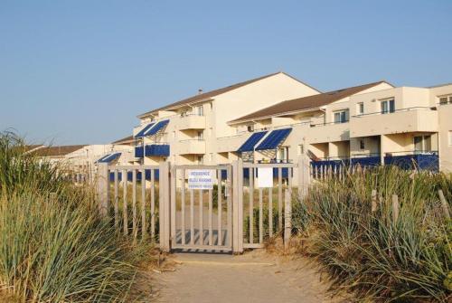 una valla frente a un edificio en la playa en Les Pieds dans l'Eau en Lacanau-Océan