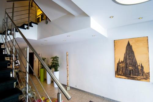 a staircase in a building with a painting on the wall at Akzent Hotel Roter Löwe in Ulm