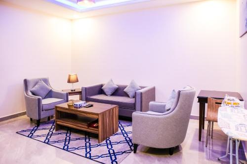 a living room with chairs and a couch and a table at درة ترف 2 للشقق المفروشة المخدمة Durra Taraf Residential 2 in Dammam