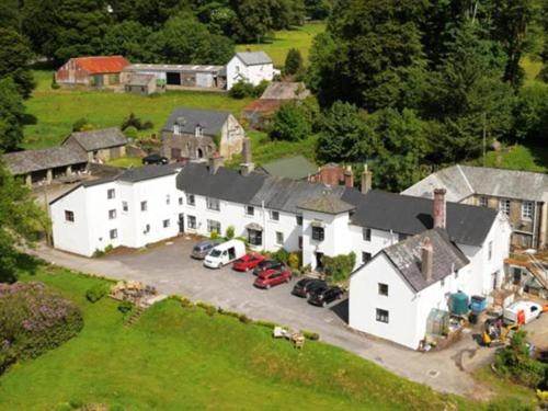 an aerial view of a white house with a parking lot at Simonsbath House Hotel in Simonsbath