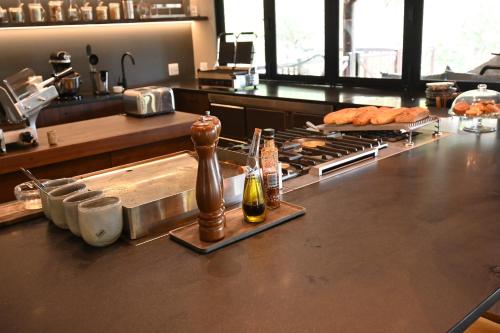 a kitchen with a counter with a stove and some food at Laluka Safari Lodge - Welgevonden Game Reserve in Welgevonden Game Reserve