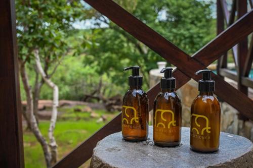 three bottles of soap sitting on top of a table at Laluka Safari Lodge - Welgevonden Game Reserve in Welgevonden Game Reserve