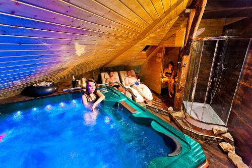 a woman is sitting in a swimming pool at Apartament Pool SPA z jacuzzi in Strzyżów