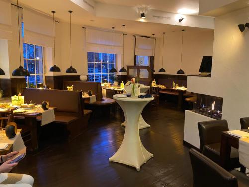 a restaurant with tables and chairs and a table in a room at MediTerra in Papenburg