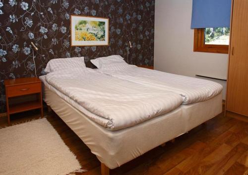 a large bed in a bedroom with at Marbyfjärden seaside village Loftet in Eckerö