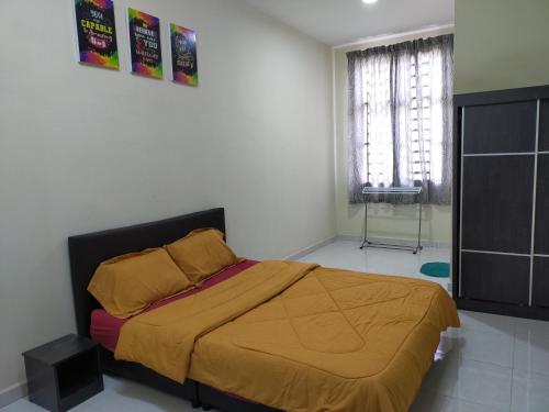 a bedroom with a bed and a dresser and a window at Fathi Homestay, Pagoh Jaya in Pagoh