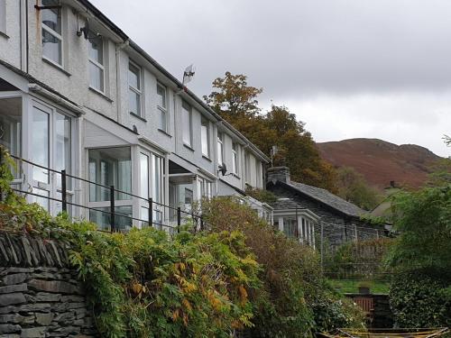 a row of houses with balconies and bushes at Quarry Bank in Chapel Stile