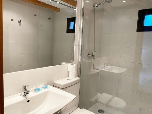 a white bathroom with a sink and a shower at INSIDEHOME Apartments - Dúplex de Javier in Valladolid
