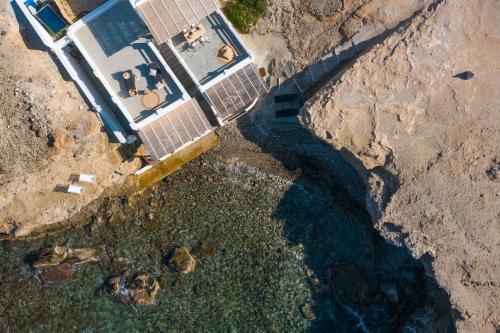 an aerial view of a house and the water at AQUA HOUSE in Pachaina