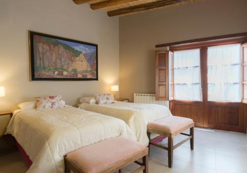 a bedroom with two beds and a window at Villa del Cielo in Tilcara