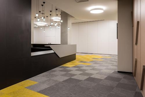 an office with a hallway with yellow and gray floors at InterContinental Malta by IHG in St Julian's