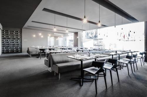 a restaurant with tables and chairs in a room at InterContinental Malta by IHG in St Julian's