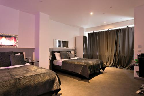 a bedroom with two beds and a window with curtains at Wellness Suite Zeist in Zeist