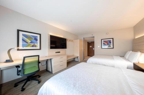 a hotel room with two beds and a desk with a computer at Holiday Inn Express & Suites - Staunton by IHG in Staunton