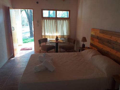 a bedroom with a bed with two towels on it at Hostal El Algarrobo in Casa Grande