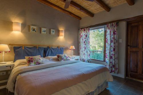 a bedroom with a large bed and a window at Villa del Cielo in Tilcara