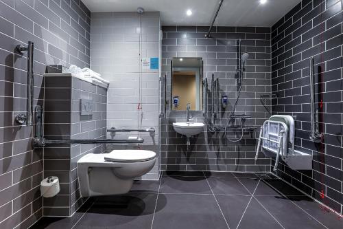 a bathroom with a toilet and a sink at Holiday Inn Express - Bicester, an IHG Hotel in Bicester