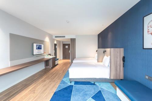 Ein Bett oder Betten in einem Zimmer der Unterkunft Holiday Inn Express Xi'an Intl Trade&Logistic Park by IHG