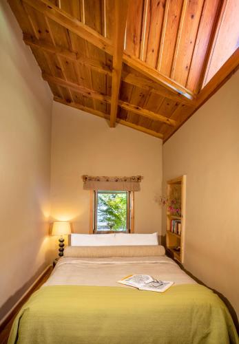 a bedroom with a large bed with a window at Mary Budden Estate in Almora