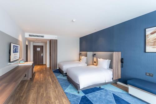 Ein Bett oder Betten in einem Zimmer der Unterkunft Holiday Inn Express Xi'an Intl Trade&Logistic Park by IHG