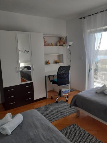a bedroom with a bed and a desk and a chair at Apartment Marinero in Šibenik