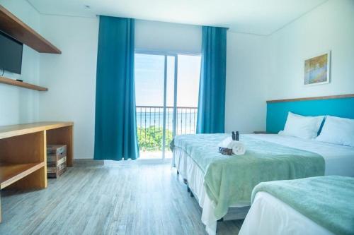 Giường trong phòng chung tại Pousada Conca di Mare - Restaurante - Pé na areia com serviço de praia