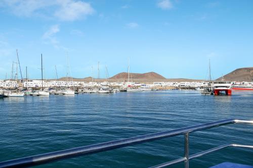 a view of a marina with boats in the water at El Graciosero in Caleta de Sebo