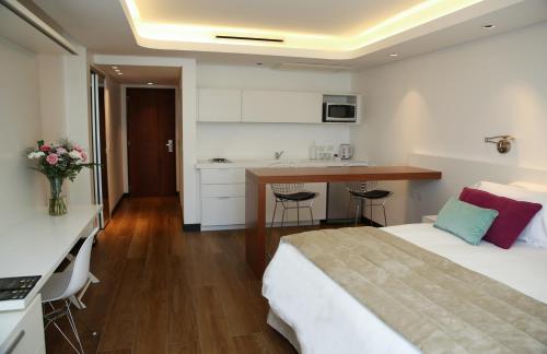 
a hotel room with a bed and a desk at Ilum Experience Home in Buenos Aires
