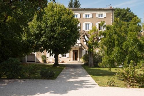 a large building with trees in front of it at La Saudade in Saint-Péray