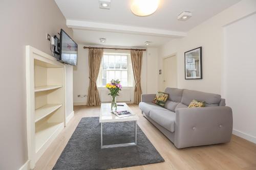a living room with a couch and a table at Hatch Street St Stephen's Green Apartments in Dublin