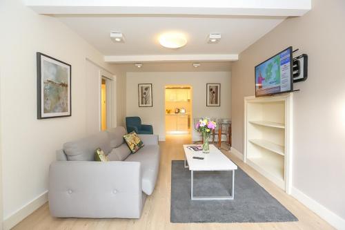 a living room with a couch and a table at Hatch Street St Stephen's Green Apartments in Dublin