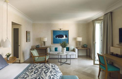 a living room filled with furniture and a large window at Villa Sant'Andrea, A Belmond Hotel, Taormina Mare in Taormina
