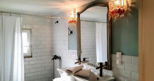 a bathroom with a sink and a mirror at thomais house corfu in Corfu