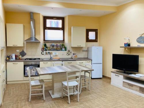 a kitchen with a table and chairs and a refrigerator at Villino Marcella in Rome