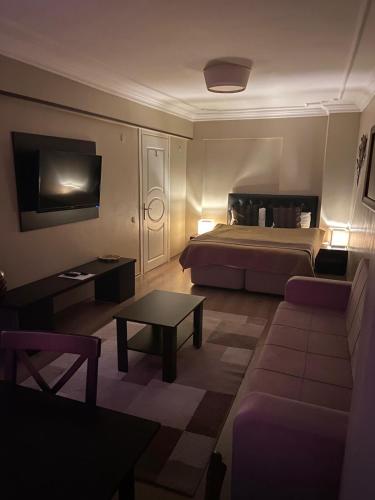 a hotel room with a bed and a couch at Lena Central Flats in Bursa