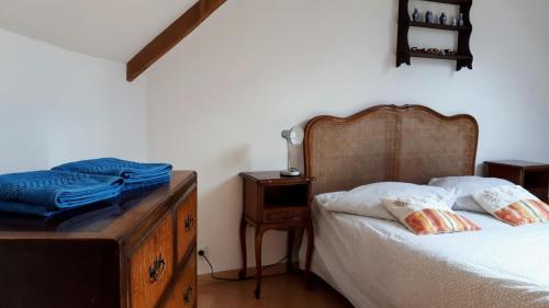a bedroom with a bed and a wooden dresser at Le Venec, Lopérec, France in Lopérec