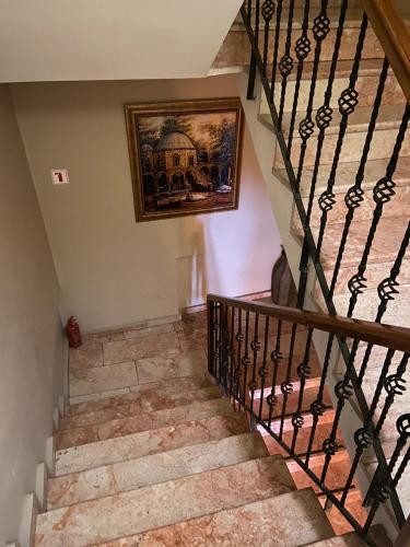 a staircase in a house with a painting on the wall at Lena Central Flats in Bursa