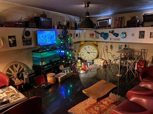 a living room with a christmas tree and a clock at Lena Central Flats in Bursa