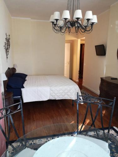 Schlafzimmer mit einem Bett und einem Kronleuchter in der Unterkunft AKIRE in Rom