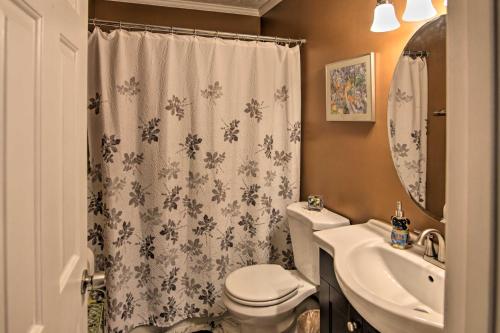 a bathroom with a toilet and a sink and a shower curtain at Lively East Nashville Pad 1 Block to Dine and Shop in Nashville