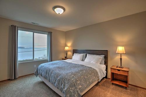 a bedroom with a bed and a large window at Birch Bay Abode Crabbing, Boating and Golfing! in Blaine