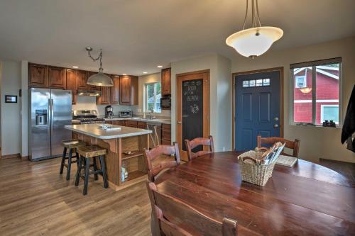a kitchen and dining room with a wooden table at Birch Bay Abode Crabbing, Boating and Golfing! in Blaine