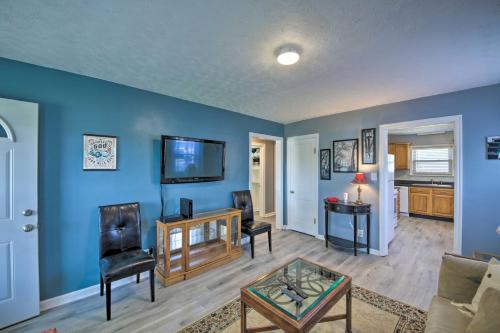 a living room with a blue wall at Steps to Speedway - Great for Race Fans! in Speedway
